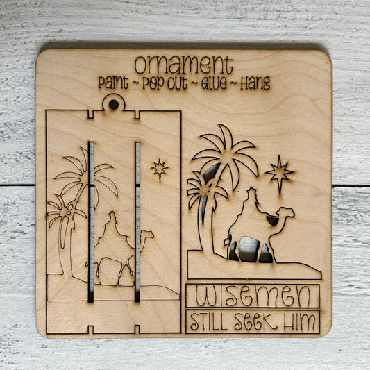Wooden nativity scene ornament with 'Wisemen Still Seek Him' text on a light wooden background