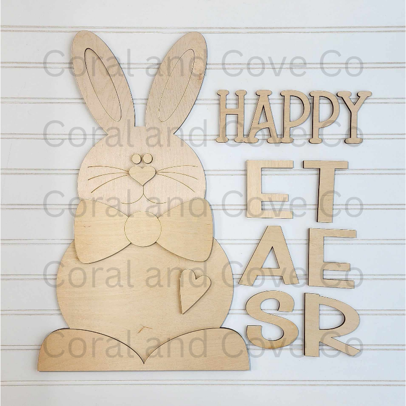 Wooden bunny cutout with 'Happy Easter' letters on a wooden background craft kit